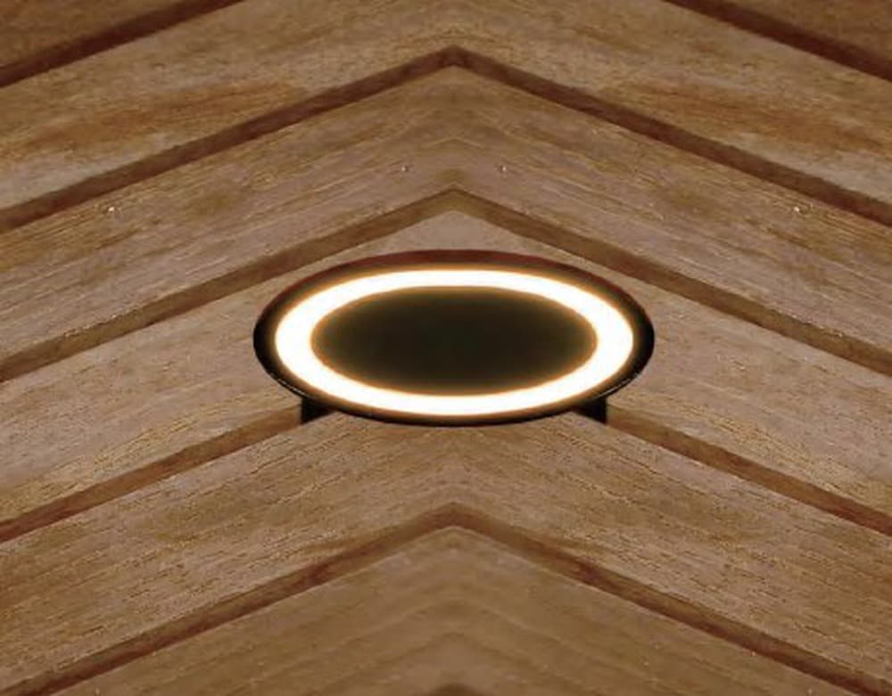 Round Deck Light, Halo, a round ring of warm light set flush in timber decking