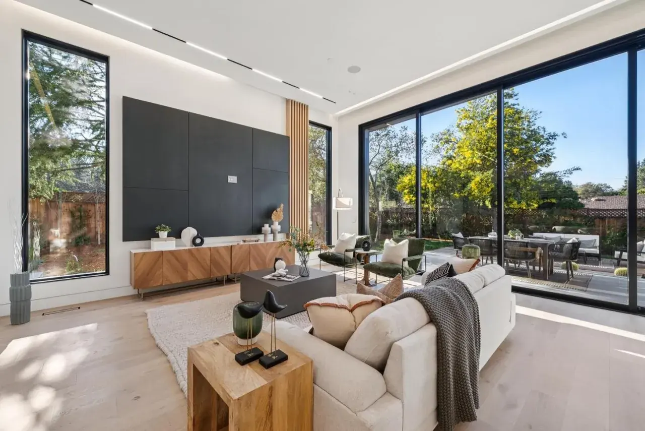 Living room with a dark feature wall and recessed linear across the ceiling