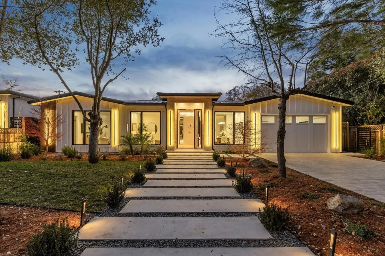 Wider view of the entry elevation at dusk