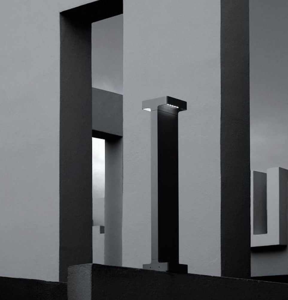Square Column Bollard, black bollards with a square cap on a slim column standing by a dark wall