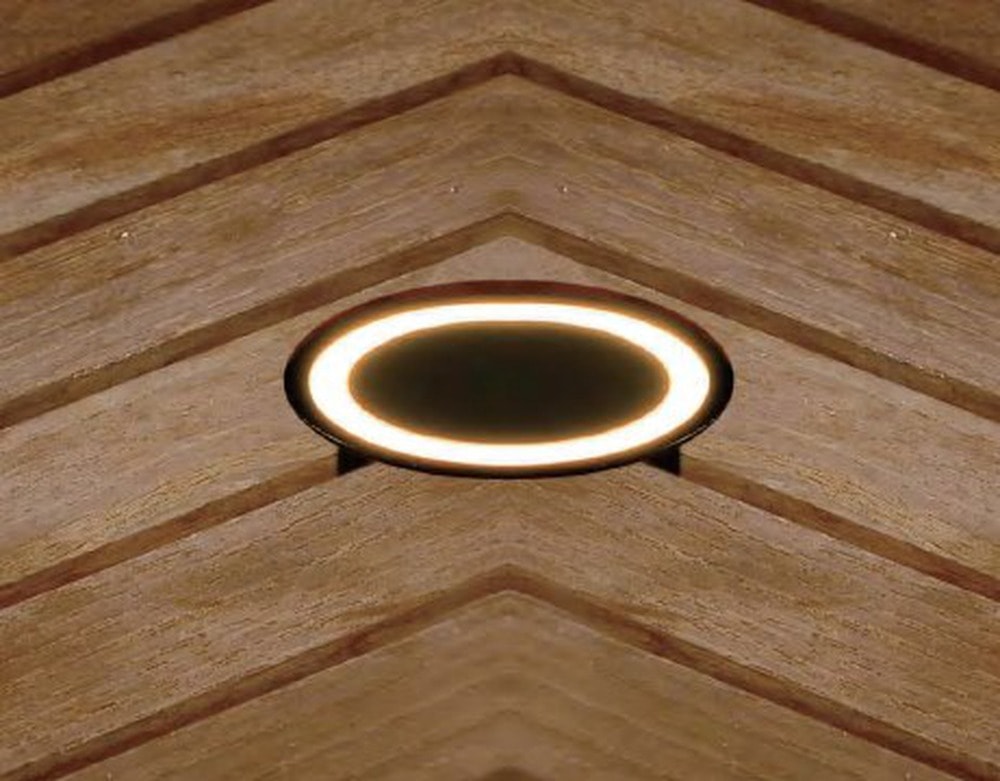 Round Deck Light, Halo, a round ring of warm light set flush in timber decking
