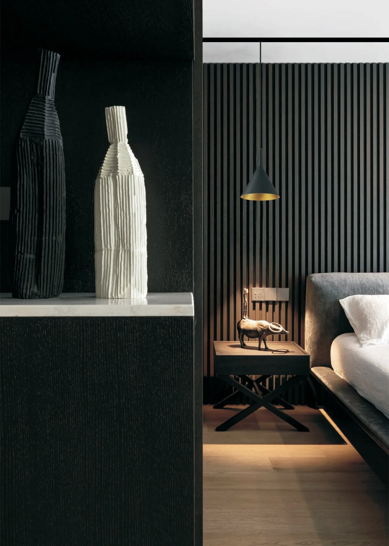 Bedroom with a magnetic track pendant beside the bed