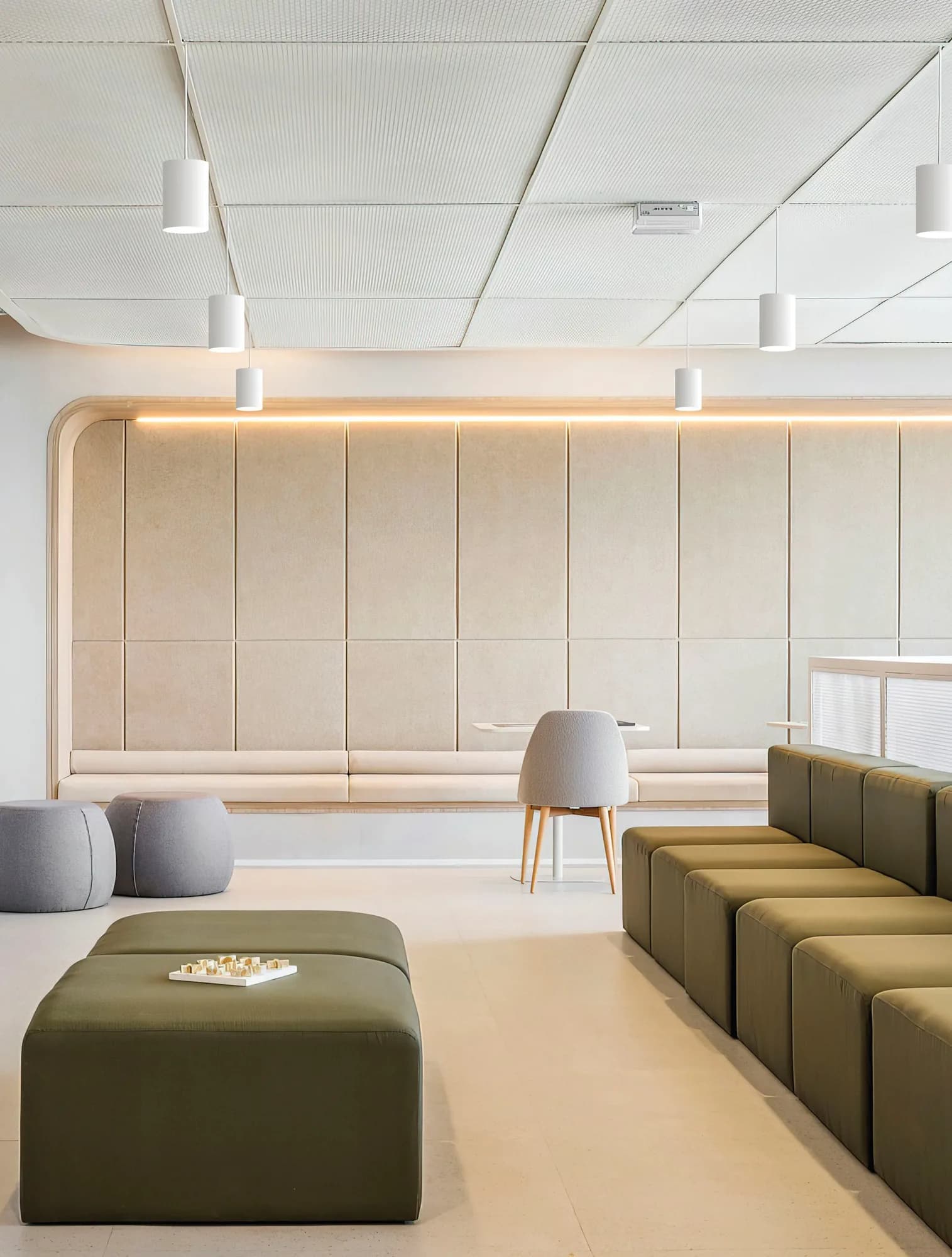 Lounge with white surface-mounted cylinder downlights on a coffered ceiling