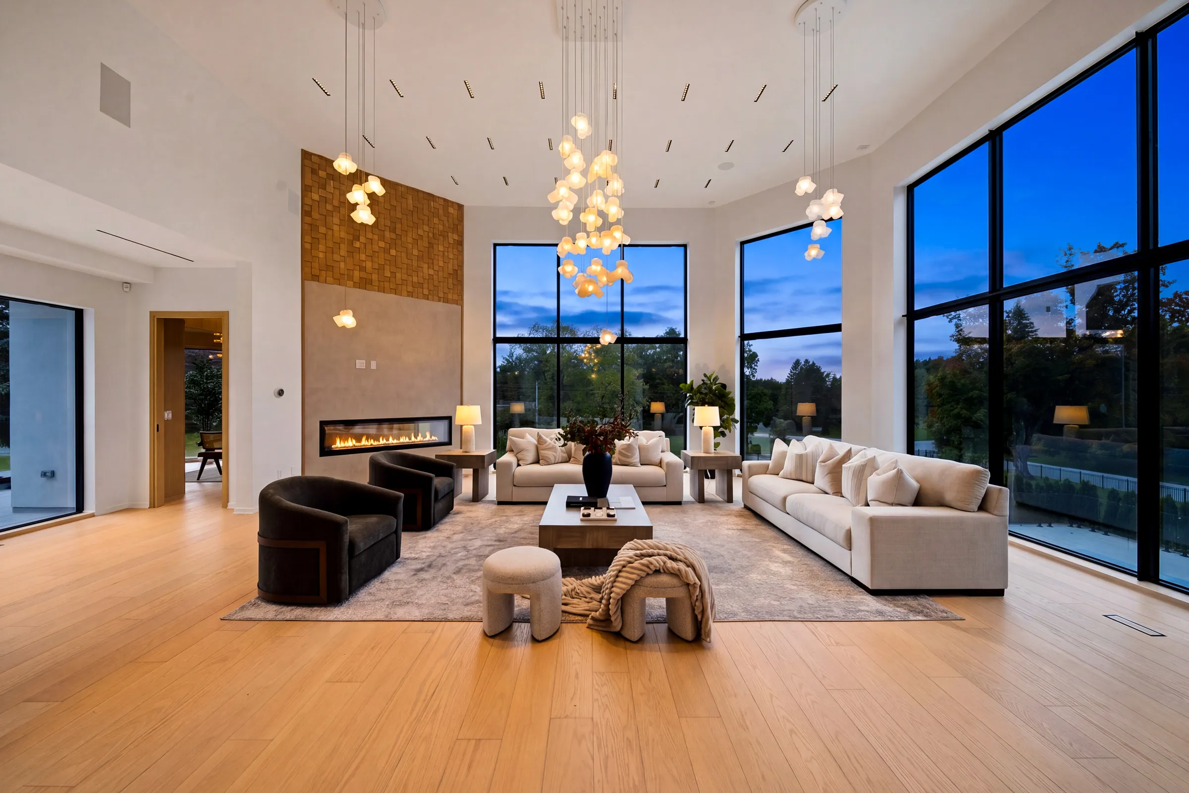 King City Residence: a double-height great room under clusters of glass pendants at dusk