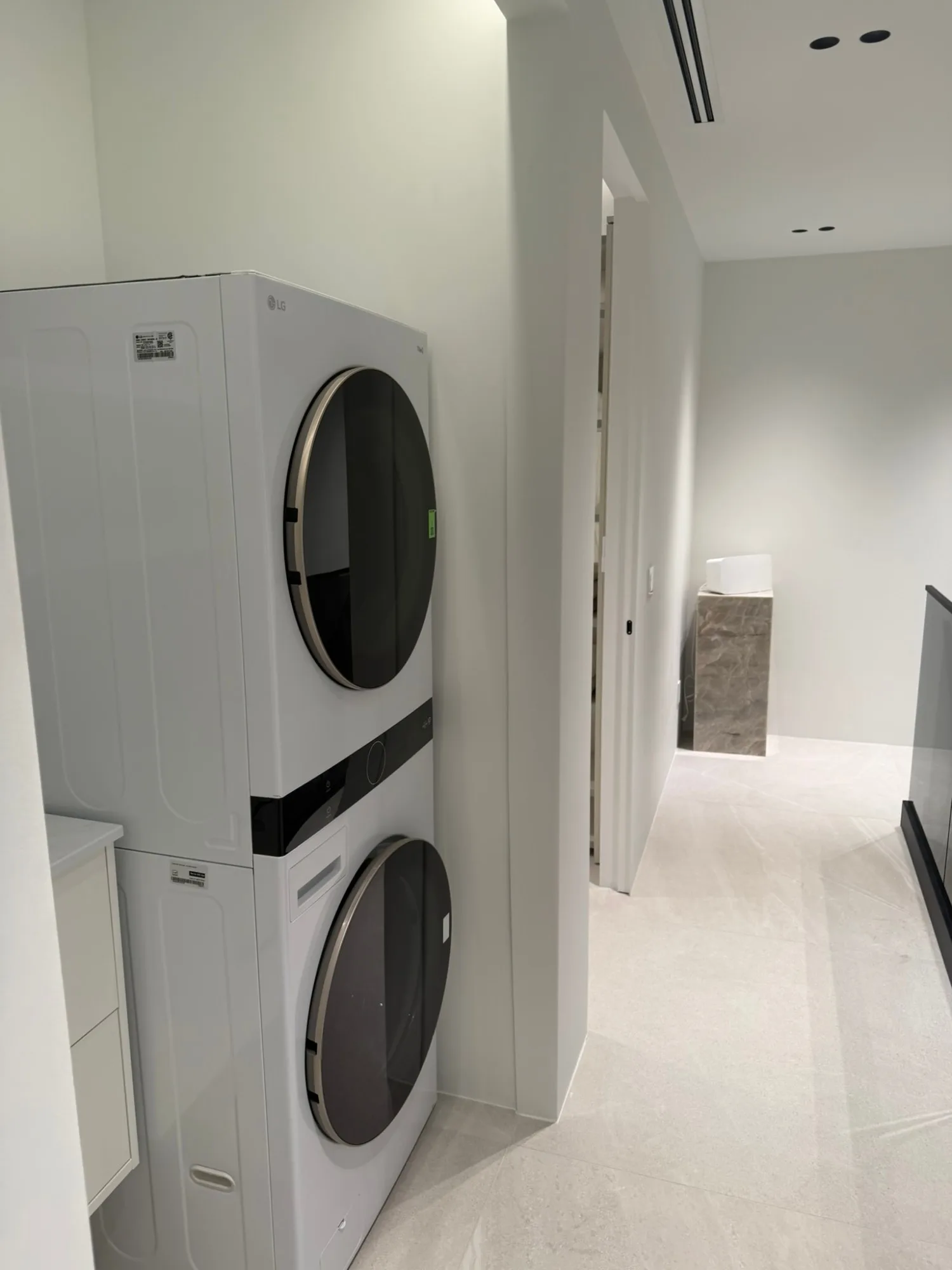 Stacked laundry pair in a hallway recess